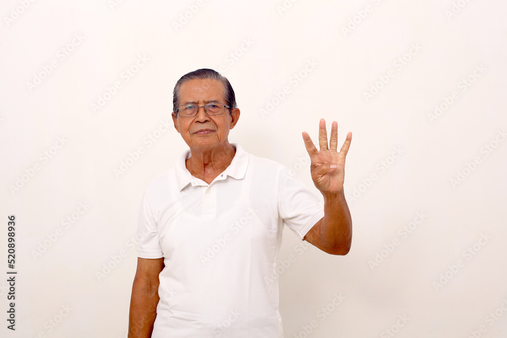 Elderly asian man standing while showing four fingers. Isolated on white background Elderly asian man standing while showing four fingers. Isolated on white background
