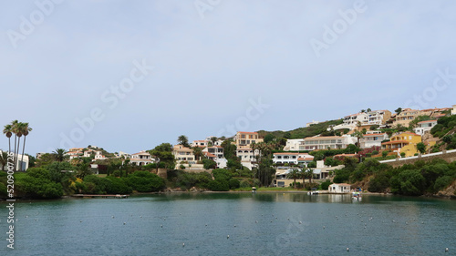 Mahon (Mao), Minorca (Menorca), Spain. Port of Mahon - the largest natural port in the Mediterranean Sea. Small islands, fortifications, villas, boats make beautiful scenery. View from the cruise boat