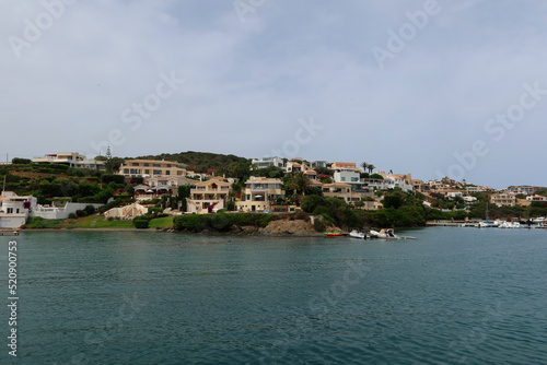 Mahon (Mao), Minorca (Menorca), Spain. Port of Mahon - the largest natural port in the Mediterranean Sea. Small islands, fortifications, villas, boats make beautiful scenery. View from the cruise boat