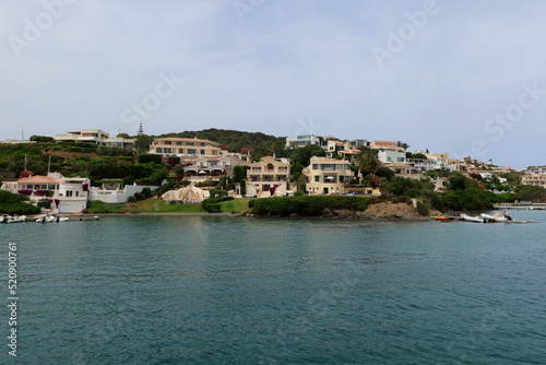 Mahon (Mao), Minorca (Menorca), Spain. Port of Mahon - the largest natural port in the Mediterranean Sea. Small islands, fortifications, villas, boats make beautiful scenery. View from the cruise boat