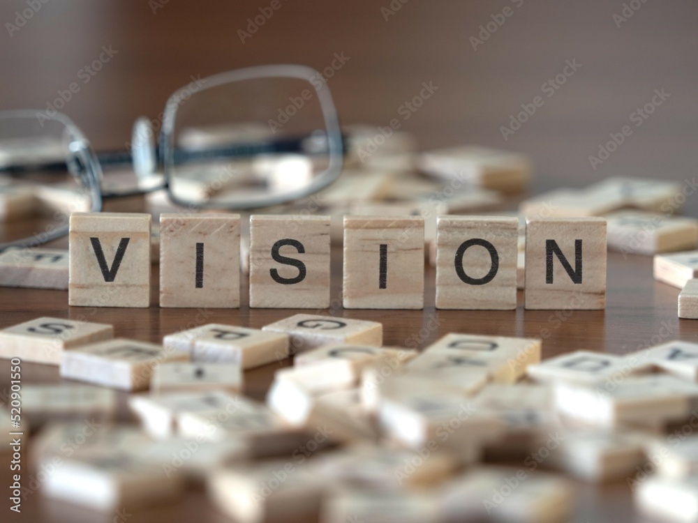 vision word or concept represented by wooden letter tiles on a wooden table with glasses and a book - obrazy, fototapety, plakaty 