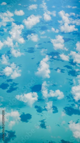 scenic aerial view on turquoise blue water with clouds
