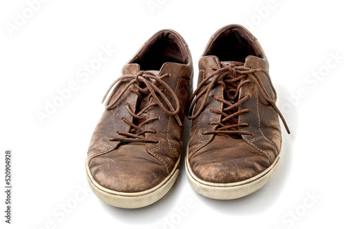 Textured worn vintage brown leather men's boots isolated on white background with copy space