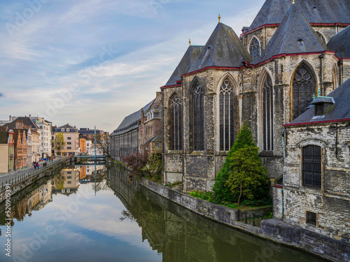Historic medieval building on Leie riveron a summer day in Ghent, Belgium