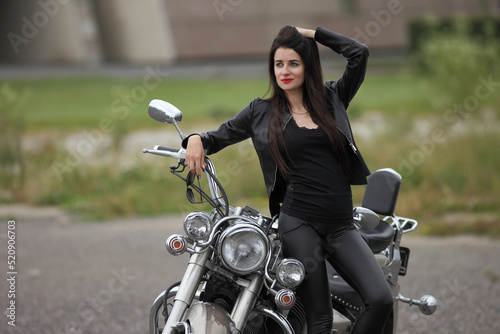 Portrait of young woman with motorcycle © zhagunov_a