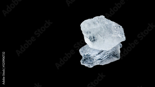 Isolated clear alum cubes on dark background concept for spa and body deodorant industrial photo
