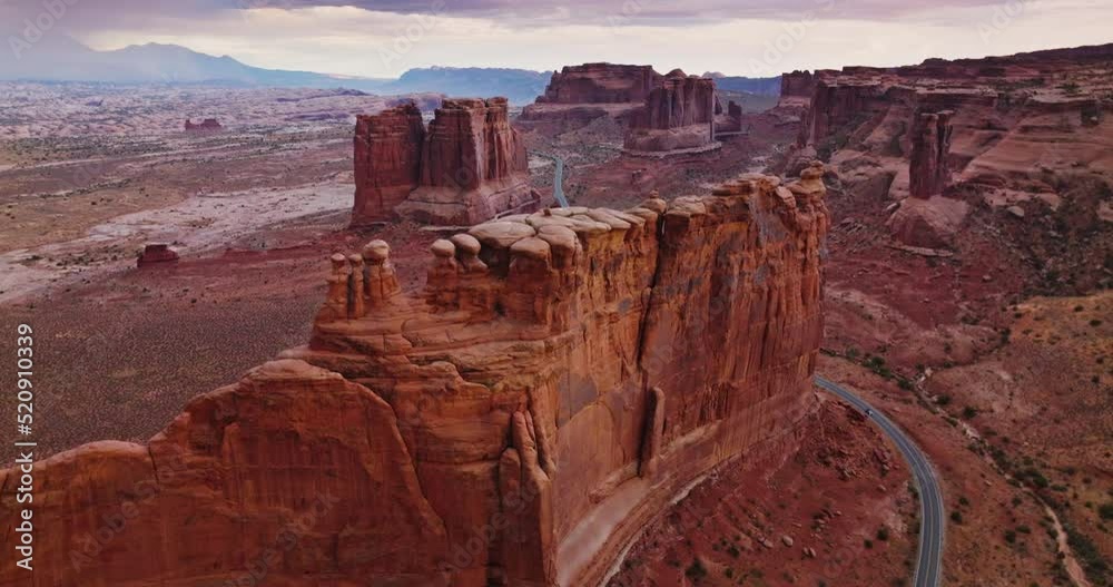 Weird rock formation of Bryce canyon in Utah, USA. Drone footage over the stunning rocks and highway crossing the dessert.