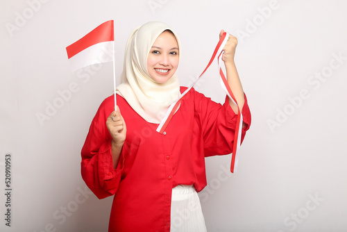 portrait of young beautiful asian woman with indonesian flag  of indonesia independence day on isolated white background photo