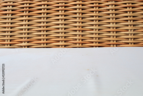 Close up wicker chair and white pad surface texture background. Utilization of rattan, especially as a raw material for furniture. traditional furniture.