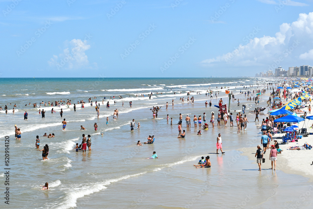Tourists and locals packing Daytona Beach on a hot summer day on the east coast of central Florida