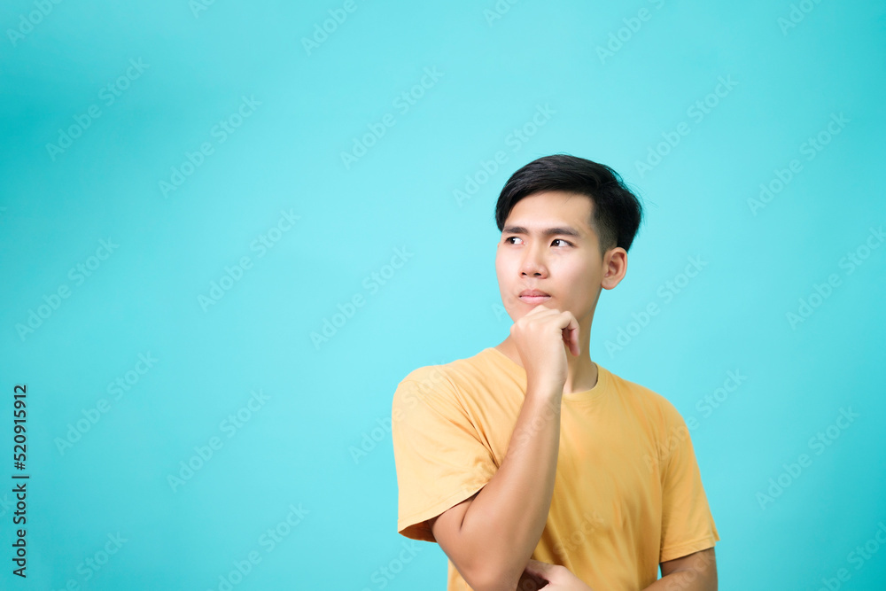 Fototapeta premium Young men poses suspiciously in the studio concept.