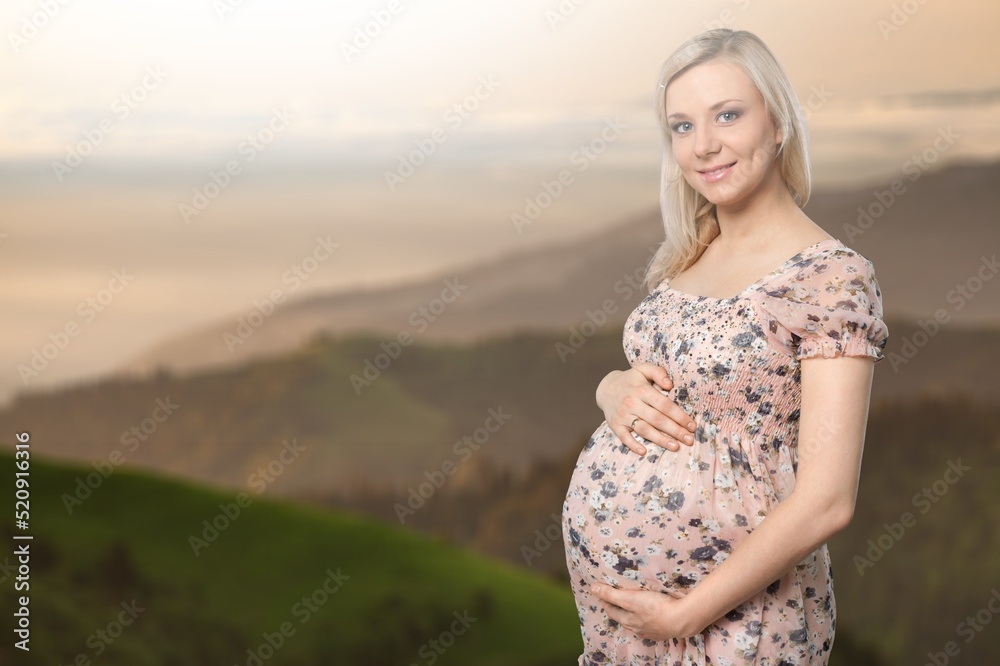 Pregnant woman during spring nature walk. Happy pregnancy outdoors active lifestyle