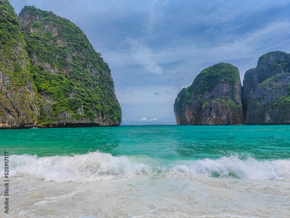 Maya bay beach with turquoise water and waves with no people in a paradise island Koh Phi Phi Le. Located in Andaman sea in Thailand