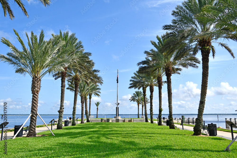 Park with palm trees along Sanford riverwalk near downtown Sanford, Florida. 