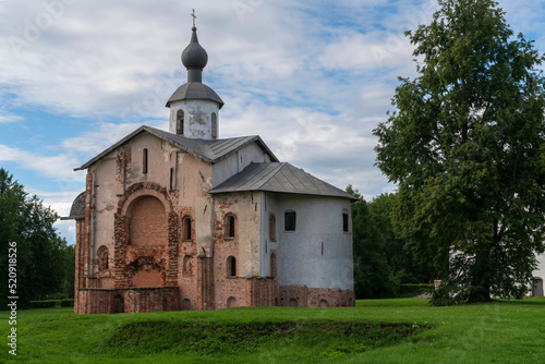 View of the Church of St. Paraskevi (Paraskevy Pyatnitsy na Torgu) on the territory of Yaroslavovo Dvorishche on a cloudy summer day, Veliky Novgorod, Russia photo