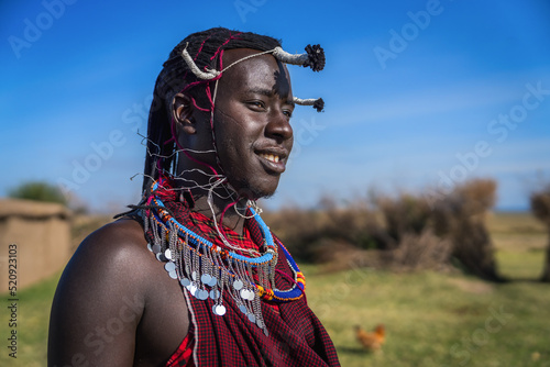 Portrait of Maasai mara man with traditional colorful necklace and clothing photo