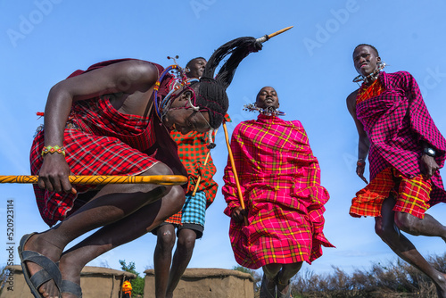 Maasai Mara man showing traditional Maasai jumping dance photo