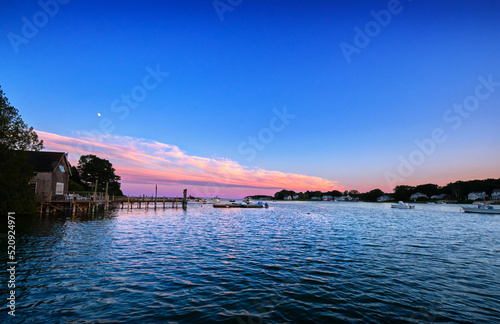 Evening moonrise over the boathouse, Cape Porpoise, Maine photo