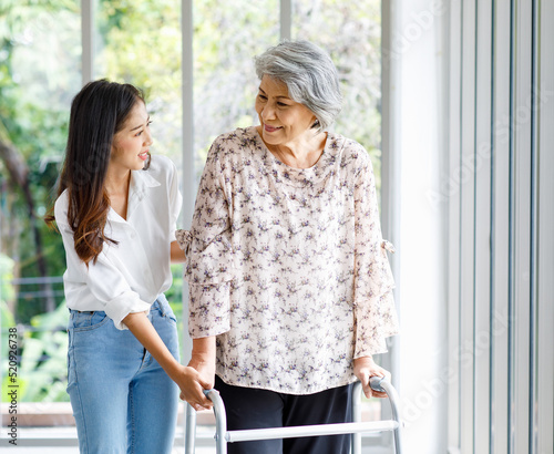 Bilde på lerret Asian young beautiful happy female granddaughter smiling helping cheerful old se