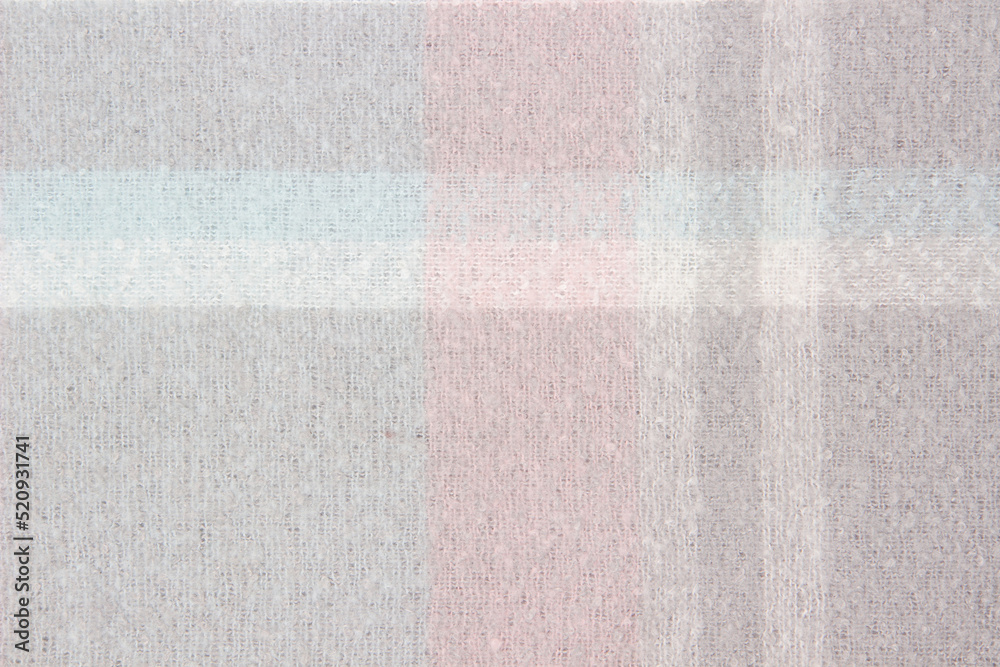 Fototapeta premium Warm woolen plaid close-up. Abstract textile background or texture. Winter cozy background for cold weather