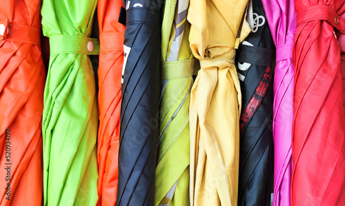Colorful umbrella background. Multicolor of umbrella hanging on the rack.