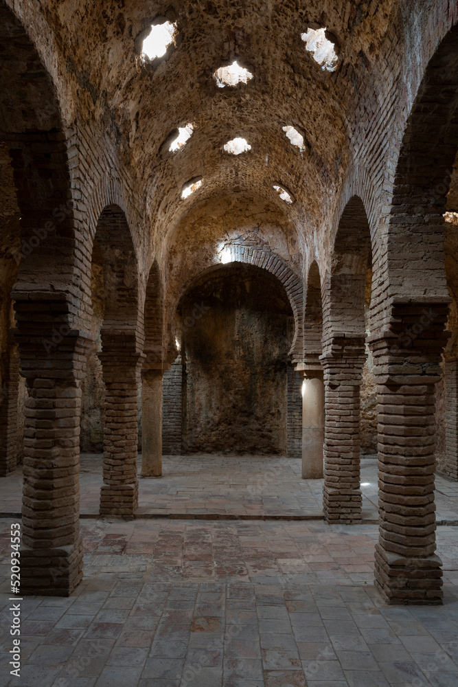 The ruins of the warm room inside the Arab baths, Ronda, Spain. Moorish architecture.
