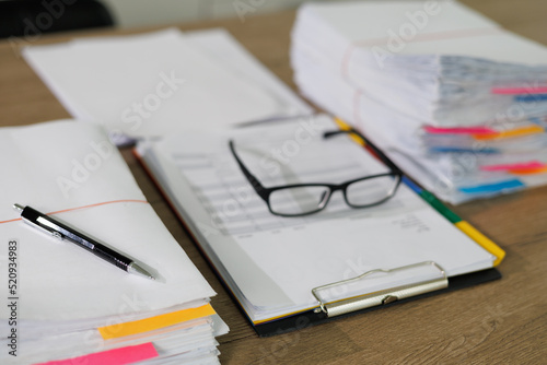 Stack of business paper Businessman working reading documents graph financial to job succes Analyze document plans documents on office desk