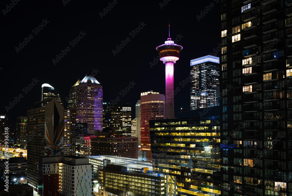 Colorful Calgary Tower and city skyline nightscape in the Province of Alberta, Canada, aerial view, long exposure photography