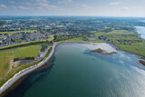 Aerial view on Ballyloughane Strand in Galway city, Ireland. High tide. Blue cloudy sky and ocean water. Popular area with amazing view and footpaths for walk close to Renmore residential area
