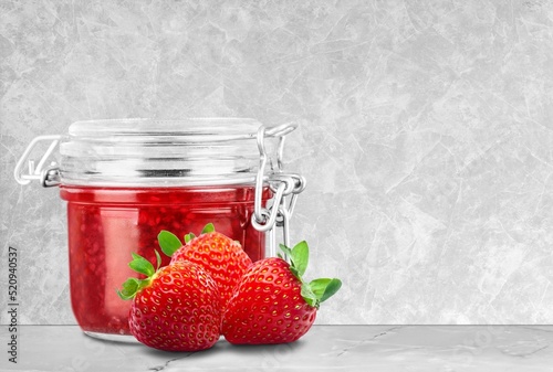 Jar of strawberry jam. Homemade strawberry marmelade and fruits.