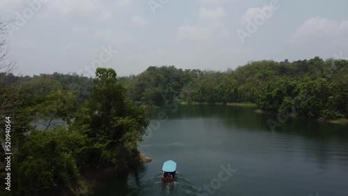 Drone video of a Boat on a Lake, flying over it and revealing the lake. photo