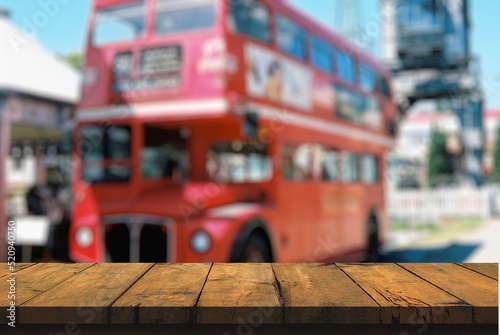 wooden floor, table with bokeh background in front of iconic red London bus