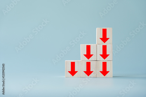 Business decline, performance decrease arrow drop down. Market loss concept diagram in arrow chart wooden block.