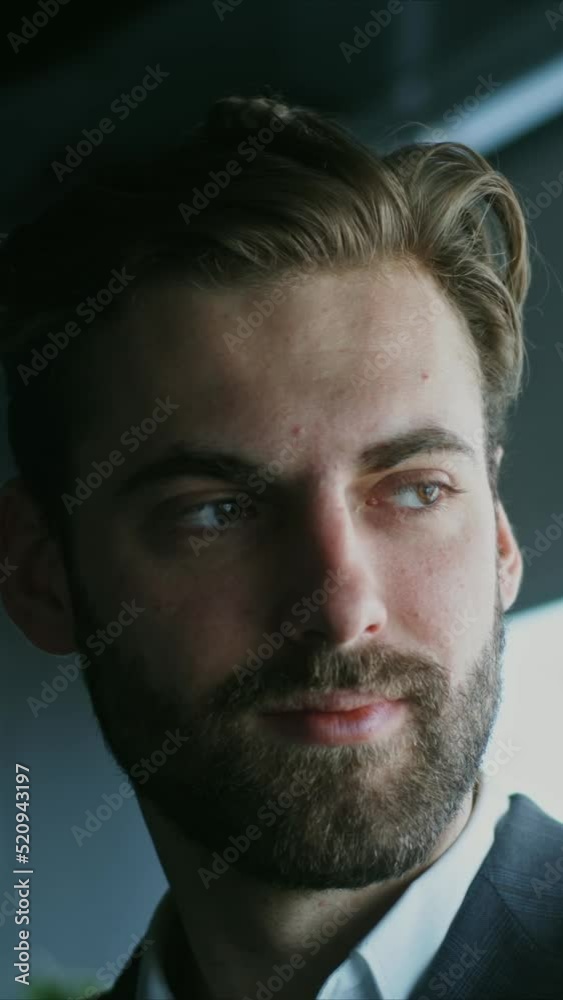 Handsome man in a business suit, smiling while looking straight into camera Handsome man in a business suit, smiling while looking straight into camera