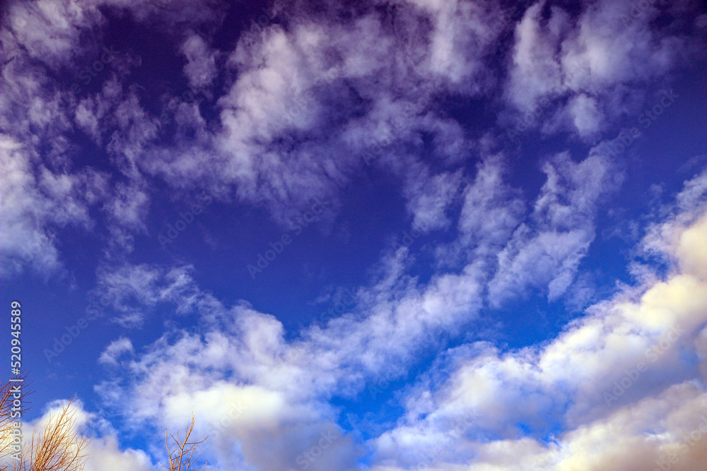 bright summer blue sky with white fluffy clouds of various shapes and ...