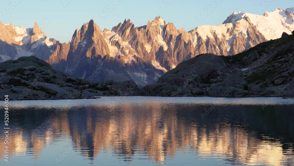 Very colorful sunset on Monte Bianco mountain range and lake Lac Blanc in the France Alps of Europe. Vallon de Berard Nature Preserve, Chamonix, Graian Alps.
