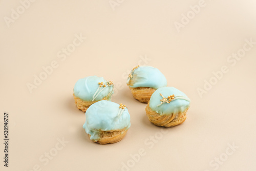 Choux pastry contains butter  water  flour  and eggs. Colorful choux with chocolate glaze.