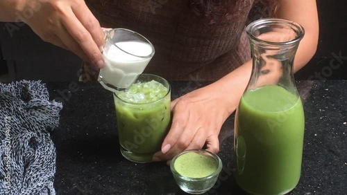 Homemade iced matcha latte with milk in a glass