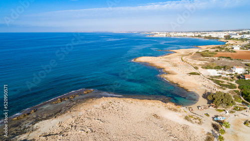Aerial bird's eye view of Ammos tou Kambouri beach, Ayia Napa, Cavo Greco, Famagusta, Cyprus. Tourist attraction bay, rocky beach with golden sand, sunbeds, sea restaurant in Agia Napa from above. © f8grapher
