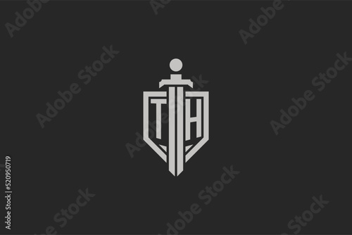 Letter TH logo with shield and sword icon design in geometric style