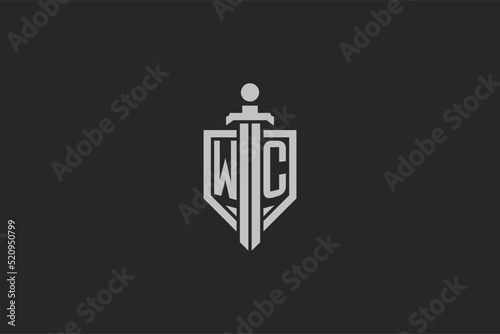 Letter WC logo with shield and sword icon design in geometric style