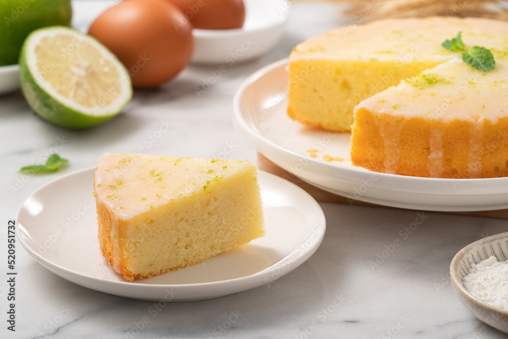 Delicious Lemon Glazed Pound Sponge cake on white marble table background.