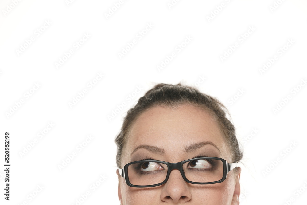 half portrait of a young chubby woman with glasses looking up half portrait of a young chubby woman with glasses looking up
