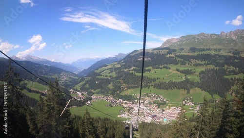Cable car ride in canton Grisons Churwalden. The gondola lift descends into the valley. You can see masts of the cable railroad photo
