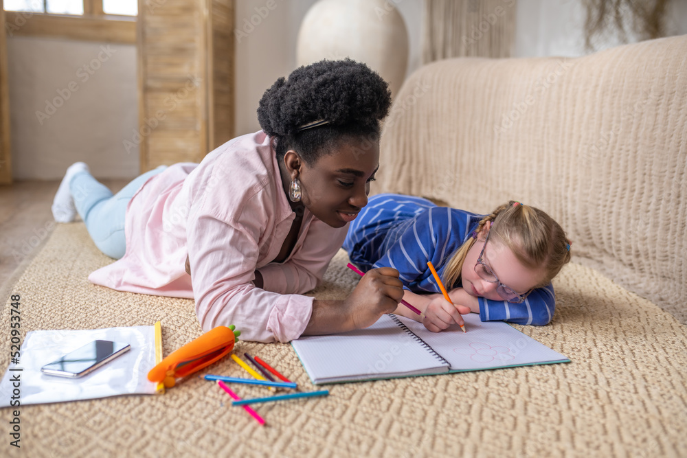 A cute girl writing something and looking involved A cute girl writing something and looking involved