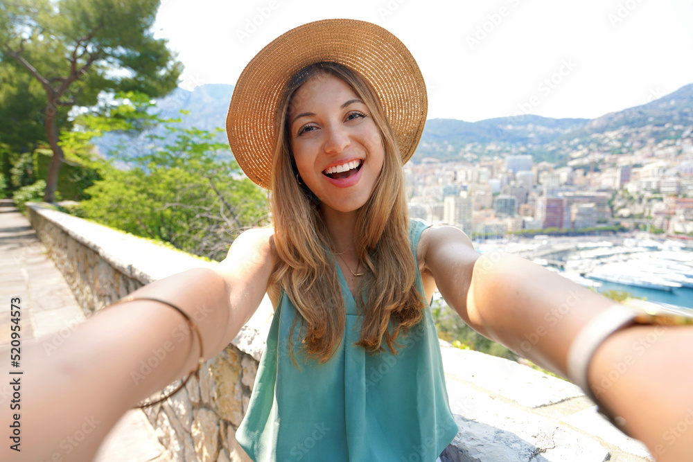 Obraz na płótnie Attractive tourist girl takes selfie picture with Monte-Carlo cityscape, Monaco w salonie