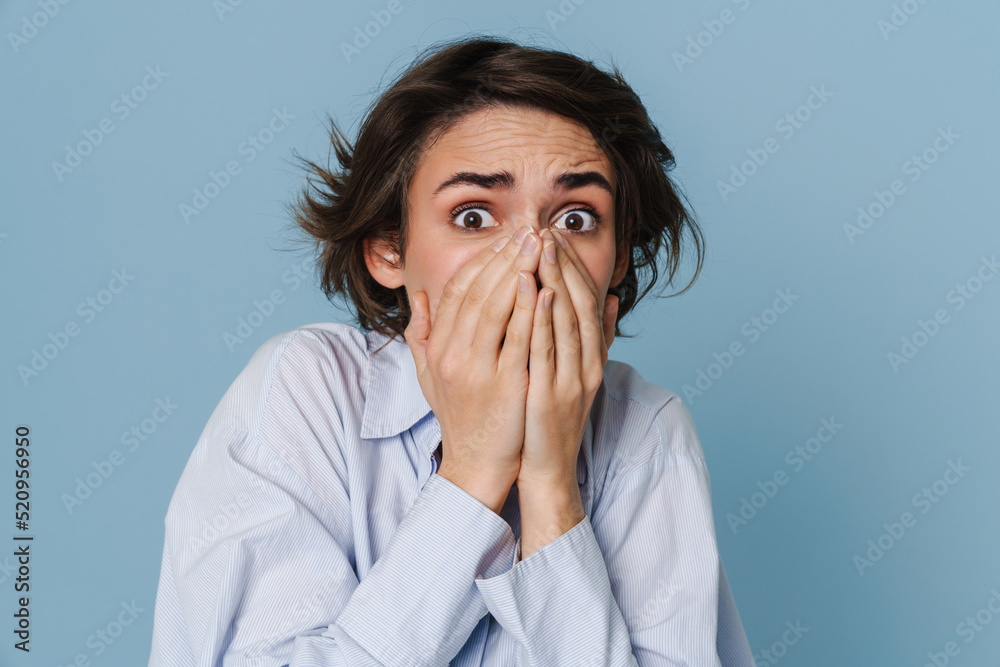 White young woman wearing shirt expressing surprise at camera