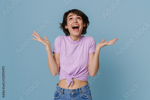 White excited woman wearing t-shirt expressing surprise at camera
