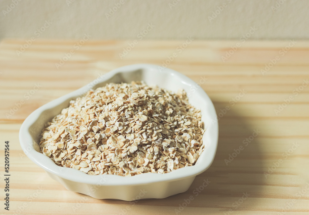 oat or granola in heart shape white bowl, ready for cooking. Healthy food concept. oat or granola in heart shape white bowl, ready for cooking. Healthy food concept.