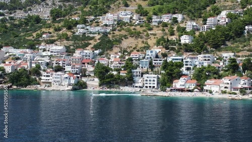 flight from the sea to the small fishing village of pisak on the dalmatian adriatic coast, a small boat departs from the port photo